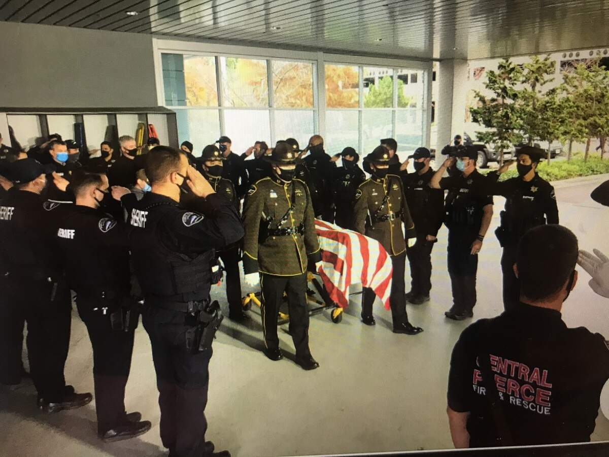 Daryl Shuey is saluted by deputies and firefighters at Good Samaritan Hospital in Puyallup following his death on Nov. 10, 2020.