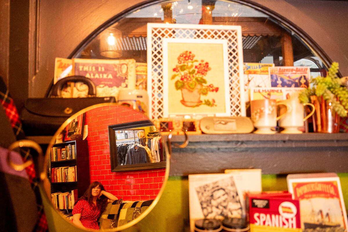 Kirsten Wenlock, owner of Stories, a vintage clothing and gift store, sits on a couch in one of the comfortable nooks of her Antique Row store front on Monday, June 26, 2023, in Tacoma.