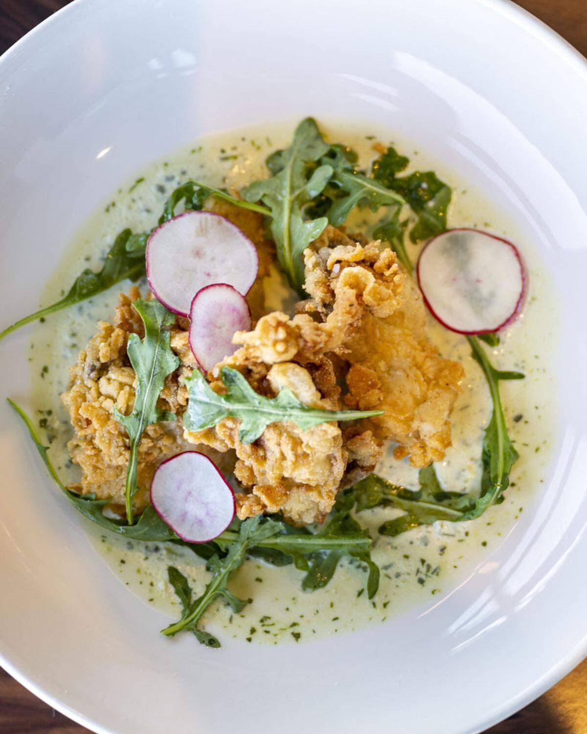 Available only at lunch, the fried oysters are filling enough to be a light meal, served over a house green goddess and arugula.