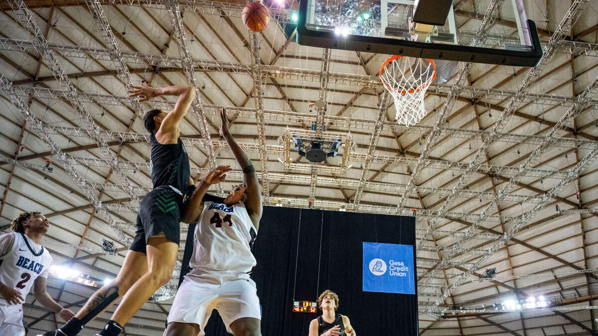 Auburn guard Trevon Blassingame (2) attempts a floater over Rainier Beach forward Josh Conerly Jr. (44) during the fourth quarter of the Class 3A championship game on Saturday, March 5, 2022, at the Tacoma Dome, in Tacoma, Wash.
