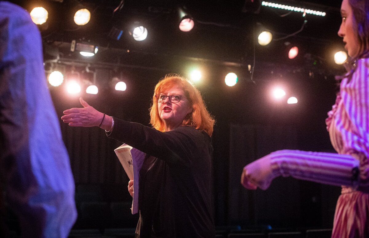 Vicki Richards works with actors onstage during a rehearsal for The Music Man at Paradise Theater in Gig Harbor, Wash., on Thursday, May 31, 2018.