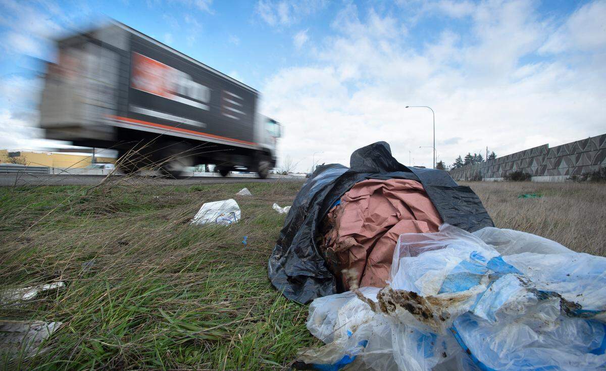 Trash lies along Interstate 5 through Tacoma, Washington, on Wednesday, Feb. 17, 2021.
