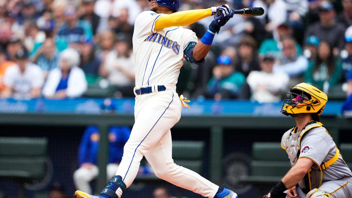 Seattle Mariners’ Julio Rodriguez follows through on a solo home run as Pittsburgh Pirates catcher Austin Hedges watches during the first inning of a baseball game Sunday, May 28, 2023, in Seattle. (AP Photo/Lindsey Wasson)