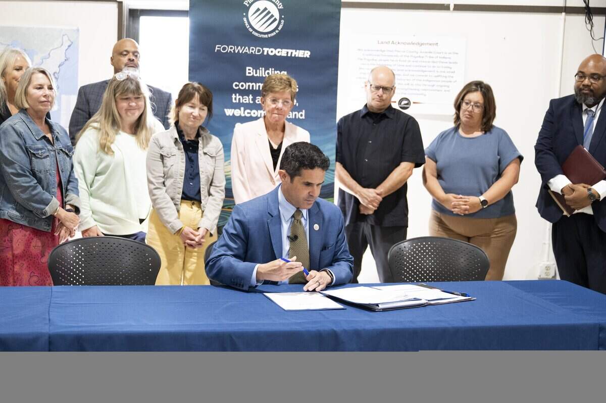Pierce County Executive Ryan Mello signs a directive to create a Juvenile Justice Task Force during a media tour of Remann Hall Juvenile Detention Center, on Monday, Aug. 18, 2025, in Tacoma, Wash..