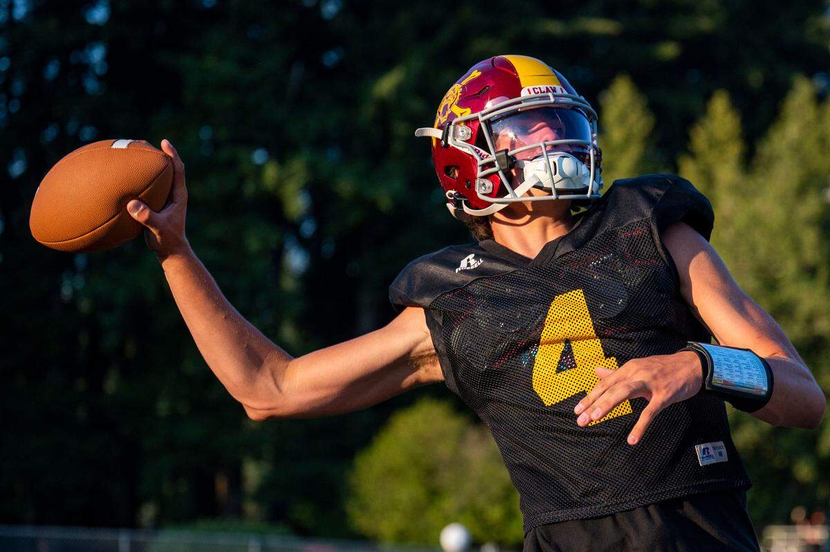 Enumclaw quarterback Gunnar Trachte winds up to throw a pass during drills on Wednesday, Aug. 24, 2022, in Enumclaw, Wash.