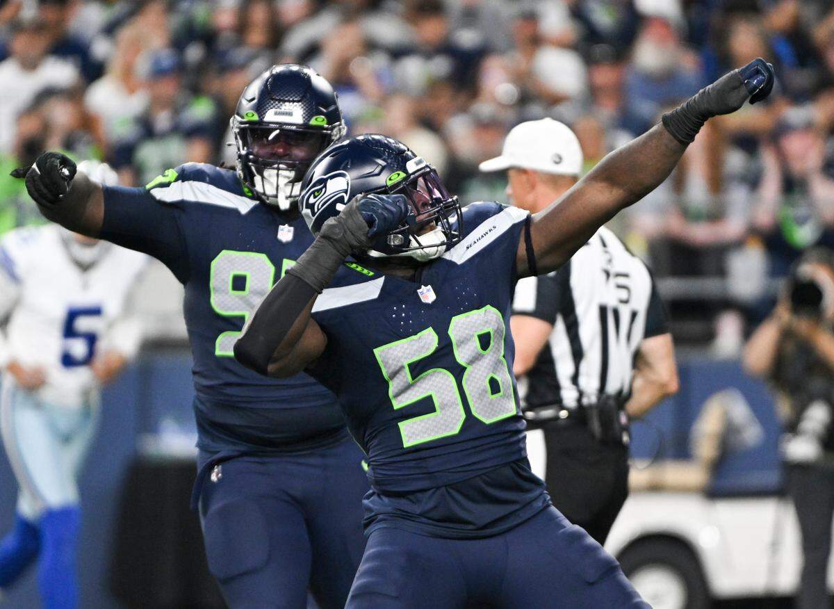 Seahawks linebacker Derick Hall (58) celebrates a sack against the Dallas Cowboys during the fourth quarter of an NFL preseason game at Lumen Field, Saturday, Aug. 19, 2023, in Seattle.