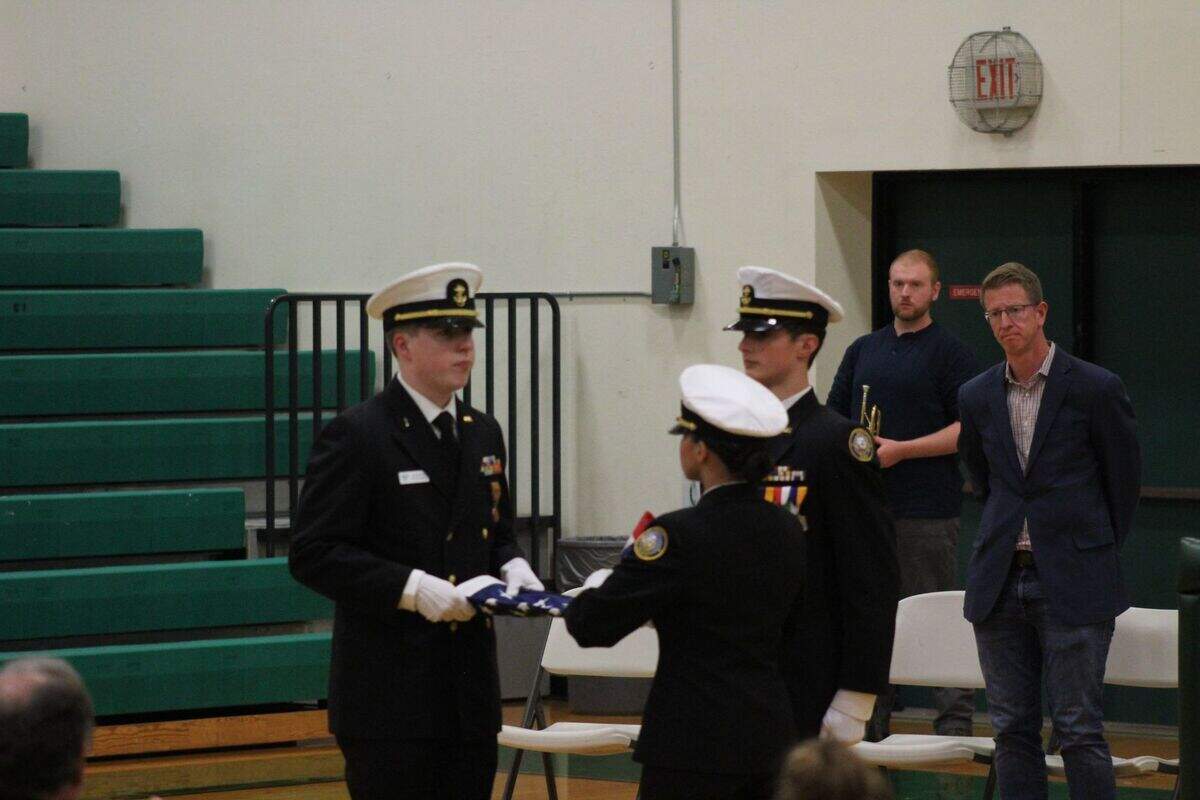 The Peninsula School District’s NJROTC color guard retired the colors and folded the flag for the family of Hugh McMillan.