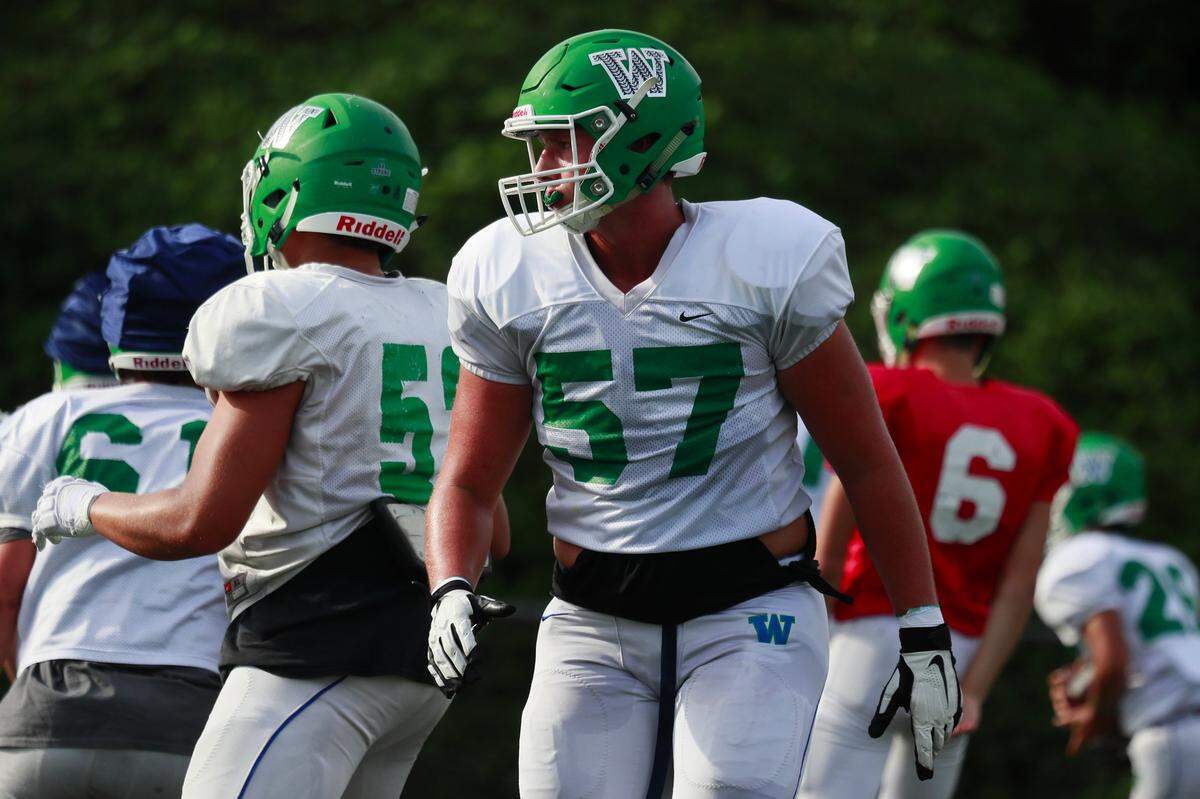 Woodinville High School lineman Levi Rogers (57) practices with his teammates in Woodinville, Wash. Wednesday, Sept. 11, 2019.
