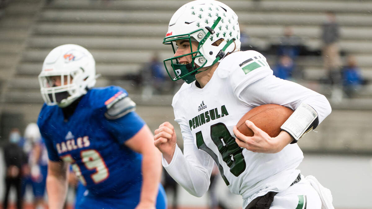 Peninsula’s Jake Bice runs during the first quarter. Peninsula played Graham-Kapowsin in a football game at Art Crate Field in Spanaway, Wash., on Thursday, March 18, 2021.