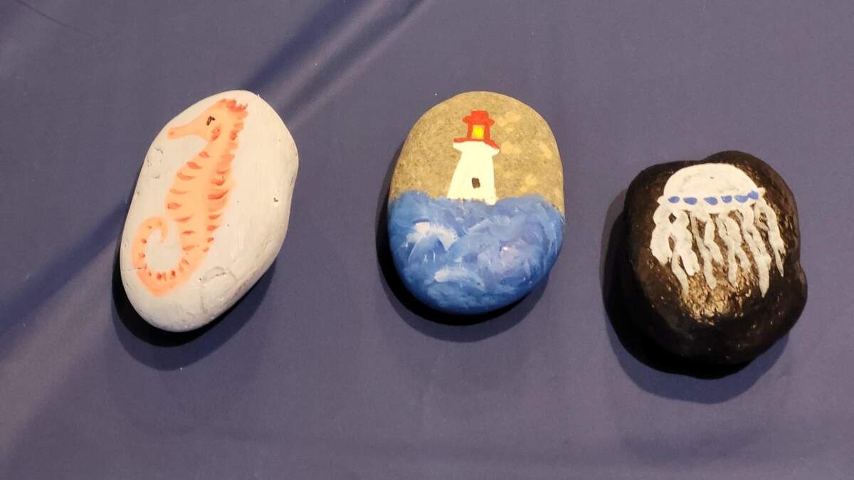 Painted rocks found in downtown Gig Harbor have a local business name on the back. The rocks can be taken to the business for a surprise.