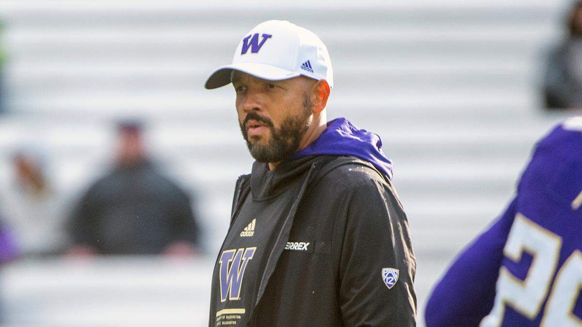 Washington head coach Jimmy Lake watches his team warm up prior to kickoff against Oregon in a Pac-12 game on Saturday at Husky Stadium in Seattle.