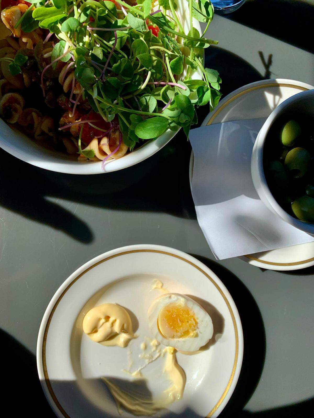 The Ruby Brink, a whole animal butcher shop, bakery and full-service restaurant on Vashon Island, is a fine place to pass the time. Pictured here is a late summer edition of puttanesca pasta salad, pickled eggs with Kewpie mayo, but not the delicious sausage on a roll, also enjoyed at this table.