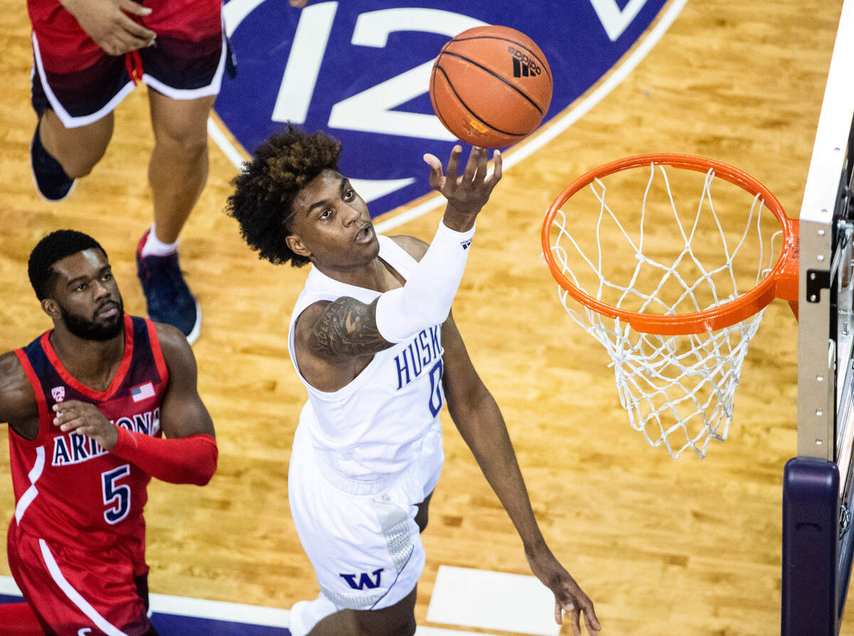 Washington Huskies forward Jaden McDaniels (0) lays in the ball during the first half. The Washington Huskies played the Arizona Wildcats in a NCAA basketball game at Her Edmundson Pavilion in Seattle, Wash., on Thursday, Jan. 30, 2020.