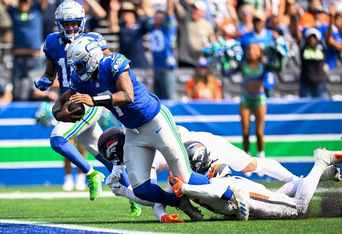 Seattle Seahawks quarterback Geno Smith (7) scores a touchdown during the second quarter of the game against the Denver Broncos at Lumen Field, on Sunday, Sept. 8, 2024, in Seattle, Wash.
