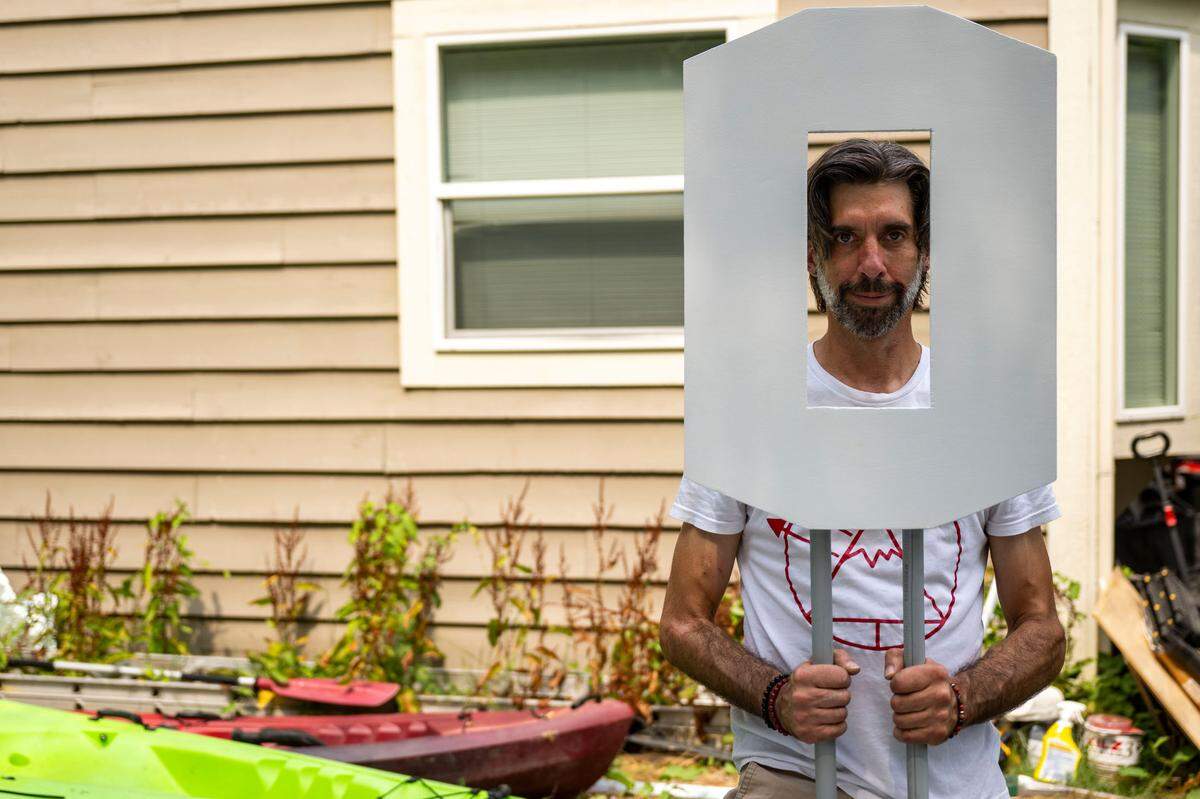 Artist John James Nelson holds a wood “O” that is part of a new “Tacoma” sign that he put up at Titlow Beach on Friday, Aug. 9, 2024, in Tacoma, Wash. The “A” on the previous that sat on off-shore pilings near the beach recently floated away so he’s decided to rebuild it from scratch.