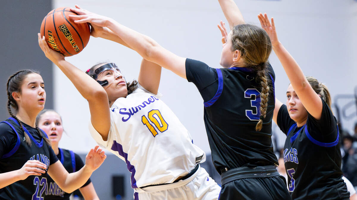 Sumner’s Olivia Collins (10) falls back as shooting the ball over Lake Washington’s Julia Benthin (3) during the girl basketball game in The Dream Showcase, on Monday, Jan. 15, 2024, in Federal Way, Washington.