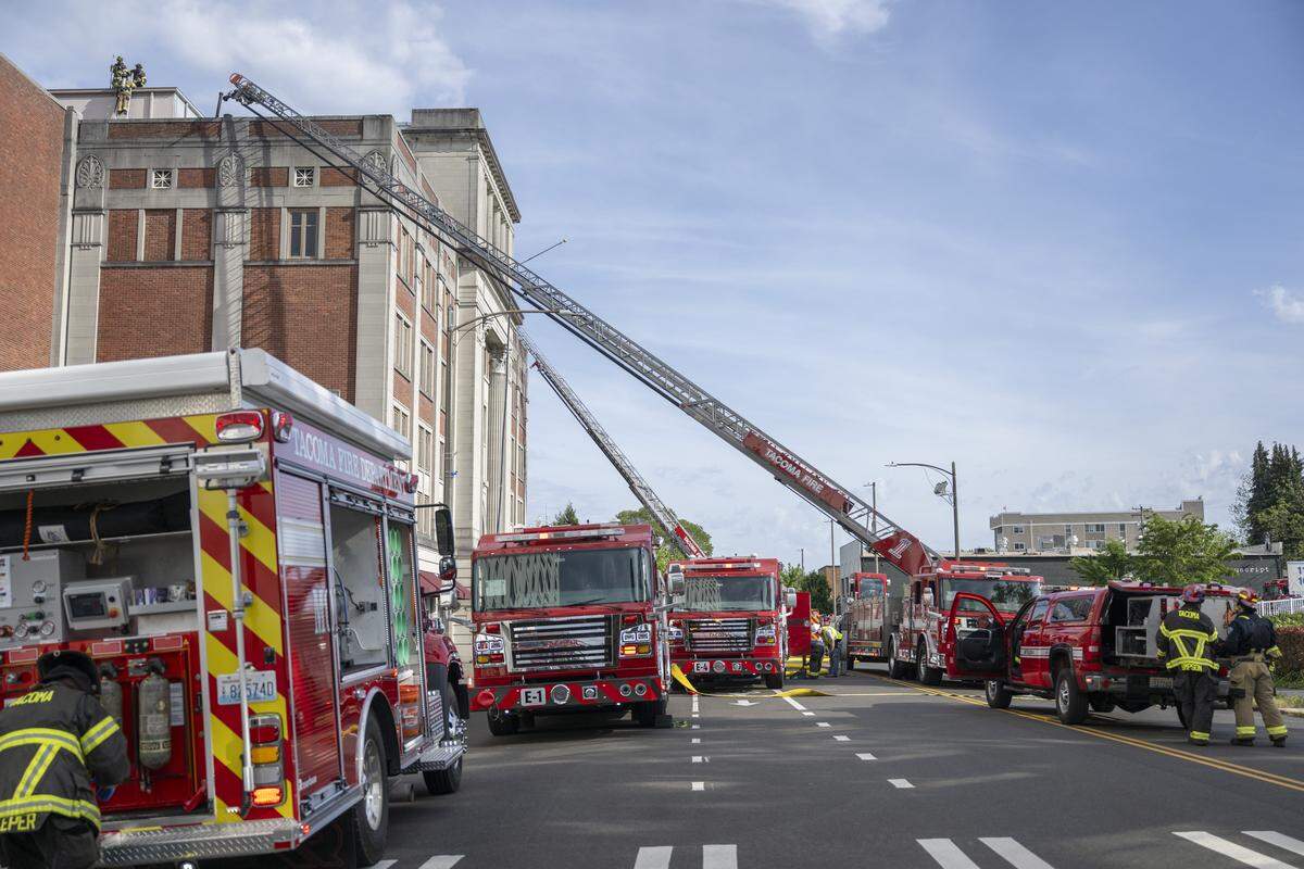 Fire fighters remain on the scene after a fire broke out on the roof of Tacoma’s Temple Theater on Tuesday, May 12, 2026, in Tacoma, Wash.