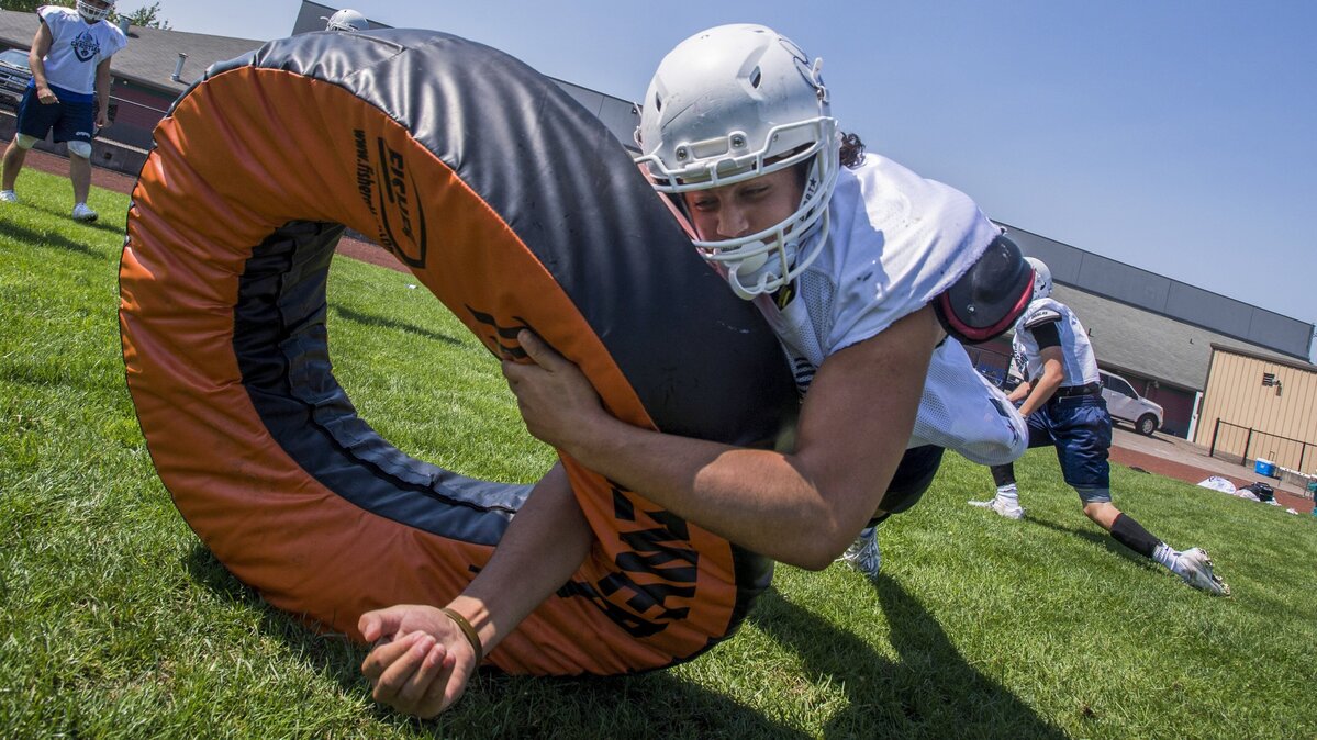 Running back / linebacker Toretto Magalei hits a rolling donut at Cascade Christian High School football practice, August 18, 2018.