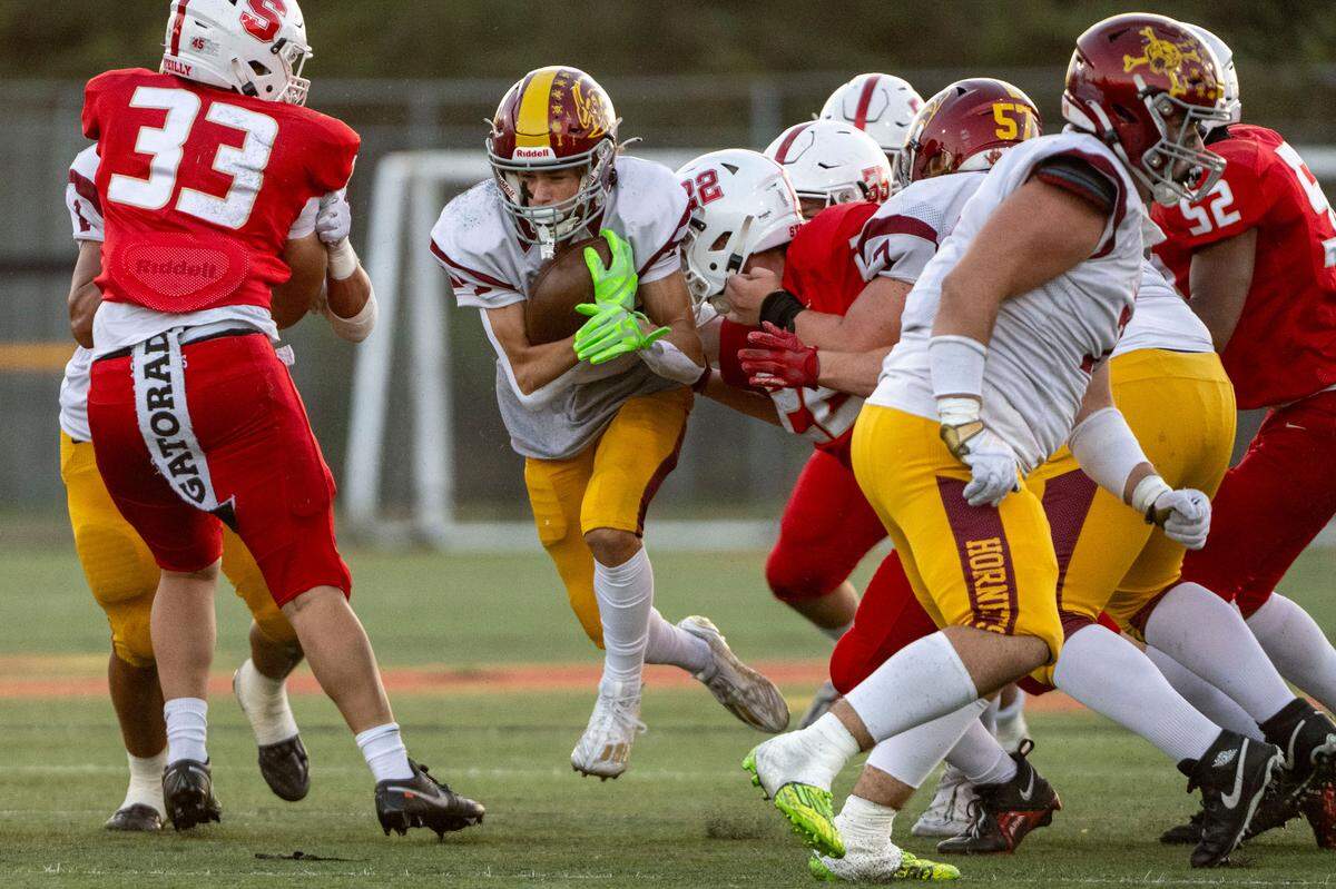 Enumclaw’s Louis Chevalier (24) splits through the Steilacoom defense on a run up the middle during the first quarter of a 2A SPSL game on Friday, Sept. 15, 2023, in Steilacoom, Wash.