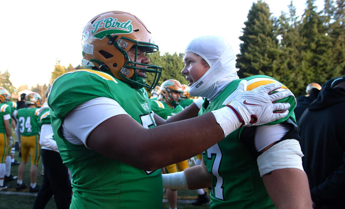 Tumwater linemen Malijah Tucker (left) aand Landon Roy celebrate a T-Bird touchdown on the sidelines during Satuday afternoon’s state playoff game against the Sehome Mariners at Tumwater District Stadium in Tumwater, Washington, on Friday, Nov. 23, 2024. Tumwater won the game, 70-7, to advance to the state semifinals.
