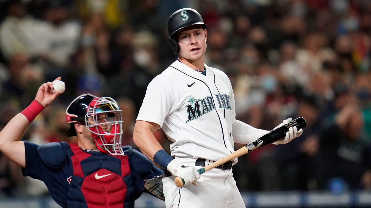 Seattle Mariners’ Jarred Kelenic, right, turns away from the plate after striking out as Boston Red Sox catcher Kevin Plawecki returns the ball to the mound in a baseball game Tuesday, Sept. 14, 2021, in Seattle. (AP Photo/Elaine Thompson)