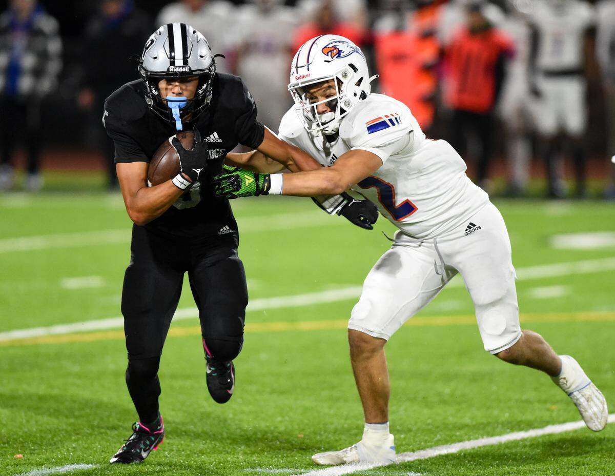 Emerald Ridge’s Tony Harste (5) carries the ball against Graham-Kapowsin’s Cohen Miller (12) during the first half of the game at Sparks Stadium, Saturday, Oct. 21, 2023, in Puyallup, Wash.