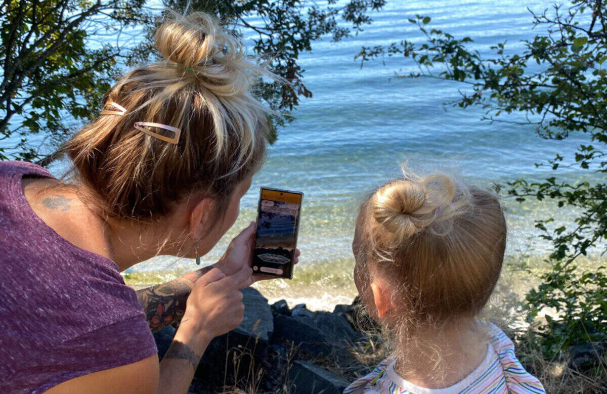 Mom and child play Agents of Discovery, the Parks Tacoma geolocation app.