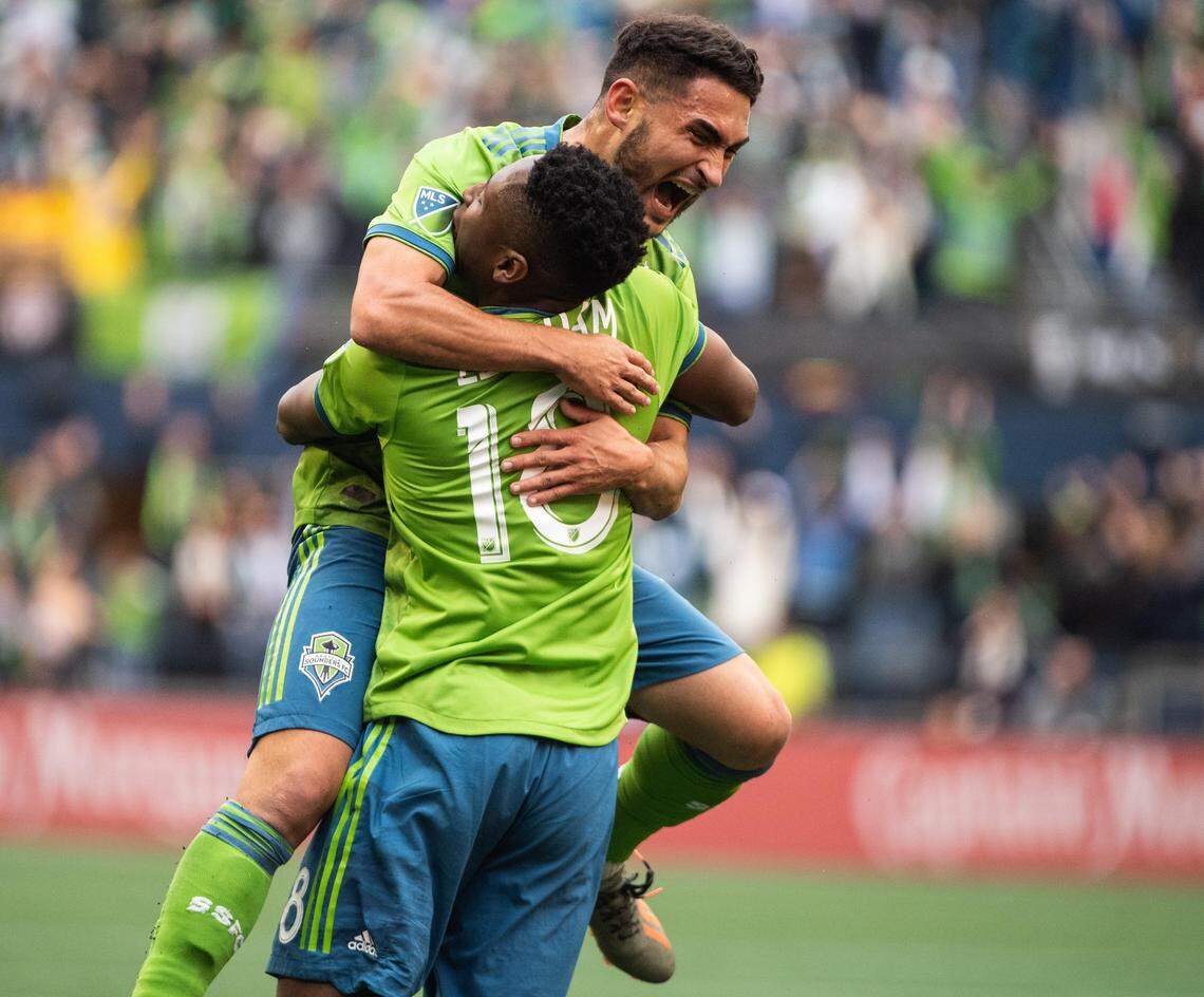 Seattle Sounders defender Kelvin Leerdam (18) and Seattle Sounders midfielder Cristian Roldan (7) celebrate a goal by Leerdam during the second half. The Seattle Sounders FC played Toronto FC during the MLS Cup at CenturyLink Field in Seattle, Wash., on Sunday, Nov. 10, 2019.