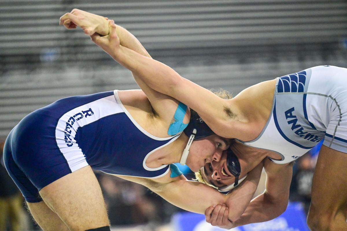 Michael Ager, of Rogers (Puyallup), and Chiawana’s Darion Johnson vie for position during the 182-pound 4A championship match at Mat Classic XXXIII on Saturday, Feb. 19, 2022, at the Tacoma Dome in Tacoma, Wash.