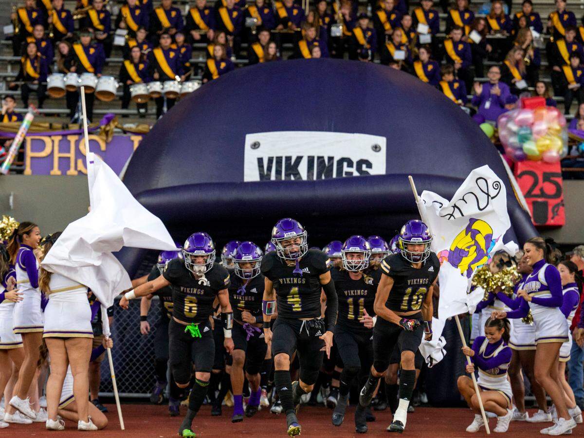 Puyallup players run onto the field prior to the start of their game against Sumner in a 4A SPSL game on Friday, Sept. 23, 2022, at Sparks Stadium in Puyallup, Wash.