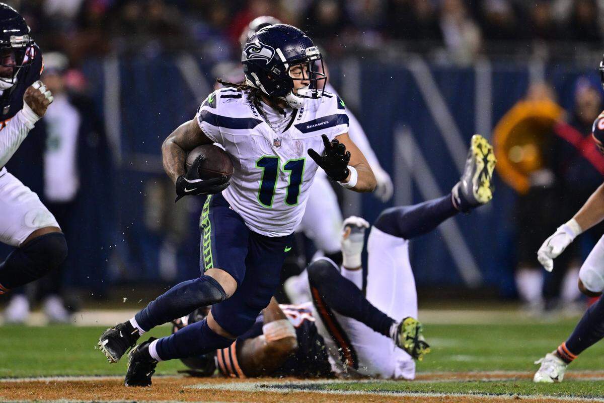 Dec 26, 2024; Chicago, Illinois, USA; Seattle Seahawks wide receiver Jaxon Smith-Njigba (11) runs after a catch against the Chicago Bears during the third quarter at Soldier Field. Mandatory Credit: Daniel Bartel-Imagn Images