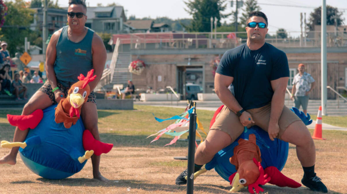 Contestants Anh Pham, left and Jake Baker compete in the inaugural Rooster Races at Skansie Brothers Park in Gig Harbor.