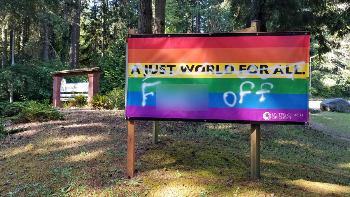 This “A Just World For All” sign was vandalized outside of the Fox Island United Church of Christ. The sign was found spray painted on Wednesday, June 21, 2023.