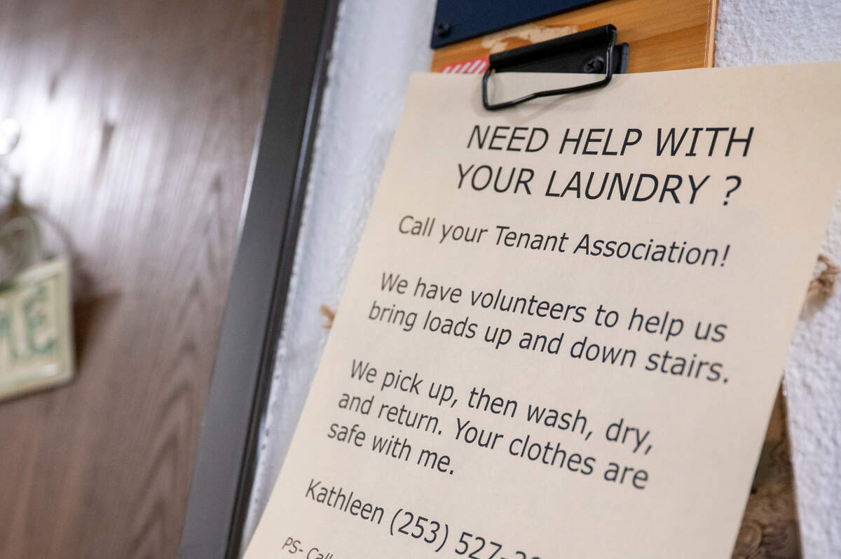 Signs posted by the Tenant Association at the Wright Park House reach out to those in need of assistance while the elevator is down at the seven-story apartment complex on Tuesday, May 13, 2025, in Tacoma.