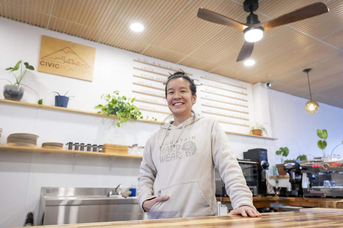Civic Roasters founder and owner Benita Ki stands behind the counter of the new brick-and-mortar cafe on Tuesday, Dec. 2, 2025, in downtown Tacoma.
