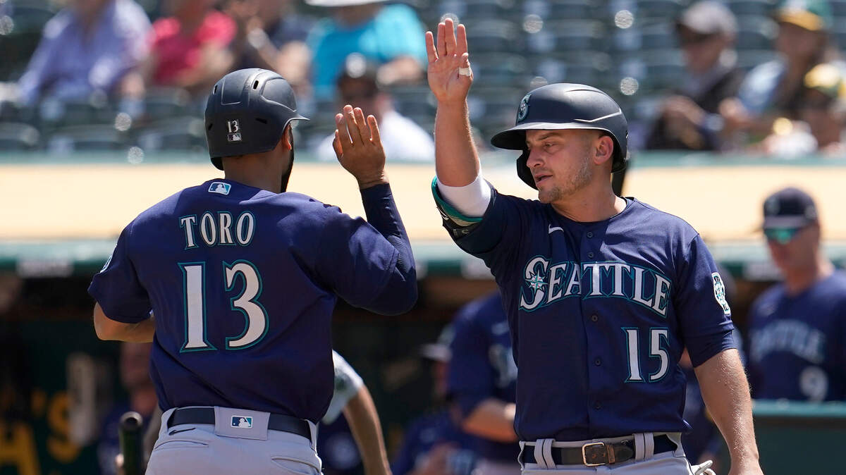 Seattle Mariners’ Abraham Toro, left, celebrates with Kyle Seager after both scored on a two-run single by Luis Torrens during the third inning of a baseball game against the Oakland Athletics in Oakland, Calif., Tuesday, Aug. 24, 2021. (AP Photo/Jeff Chiu)