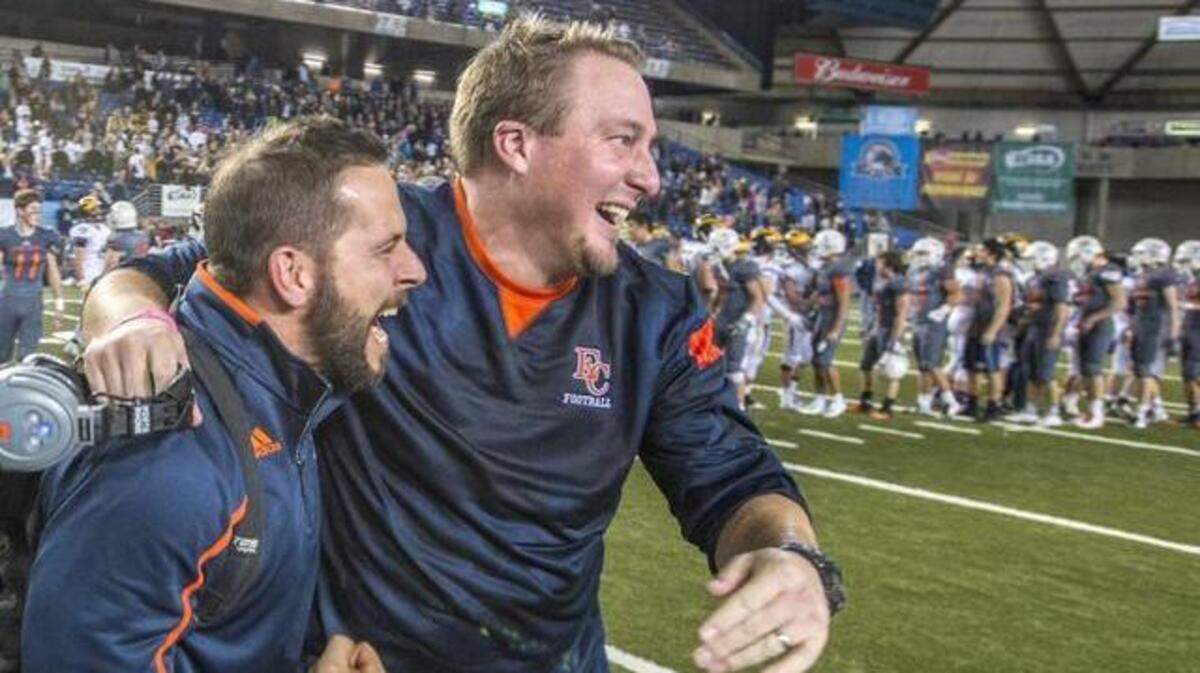 Assistant coach Aaron DeCollibus (left) and head coach Jeremy Thielbahr of the Eastside Catholic Crusaders are ecstatic after winning the WIAA state AAA championship football game in the Tacoma Dome, December 5, 2014. Eastside Catholic beat Bellevue, 35-13.