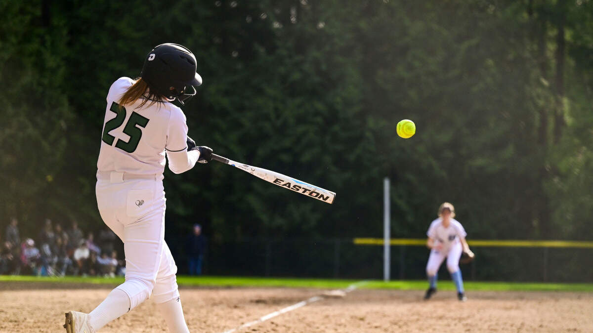 Peninsula’s Aislinn O’Reilly makes contact with a pitch during the bottom of the sixth inning of a 3A South Sound Conference game against Gig Harbor on Wednesday, April 6, 2022, at Peninsula High School in Gig Harbor, Wash.