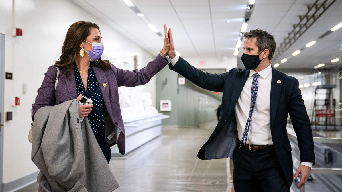 Reps. Adam Kinzinger of Illinois and Jaime Herrera Beutler of Washington State, two of 10 Republicans who voted to impeach President Donald Trump, exchange a high five at the Capitol Wednesday. The other Republican “yes” vote from Washington state belonged to Rep. Dan Newhouse of Sunnyside.