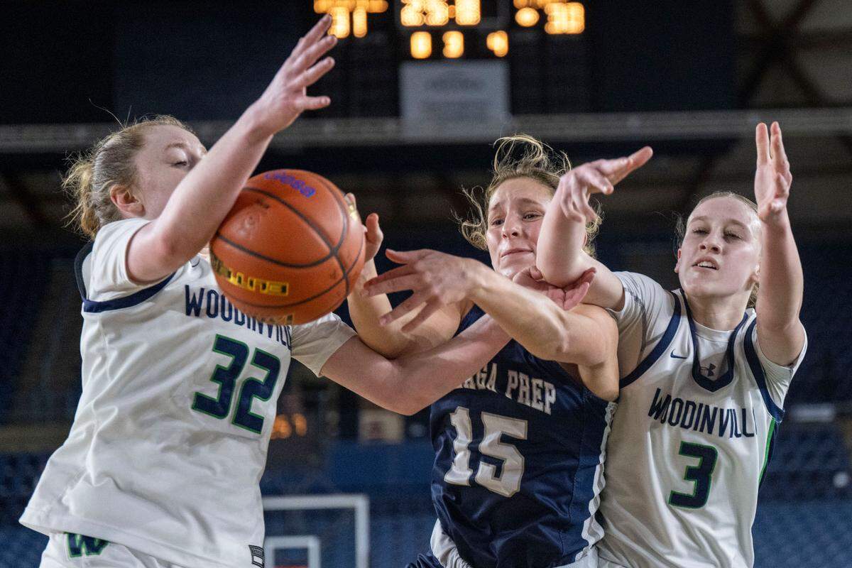 Gonzaga Prep guard Julia Few (15) battles for a rebound with Woodinville forward Brooke Beresford (32) and forward Lyla Kahrimanovic (3) during the third quarter of a Class 4A consolation game on Friday, March 3, 2023, in Tacoma, Wash.