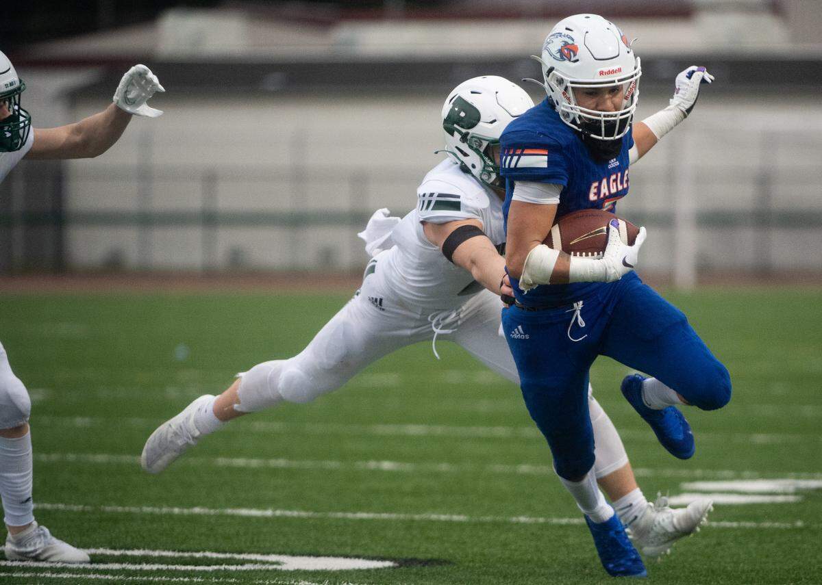 Graham-Kapowsin’s Va’a Hansen runs in the fourth quarter. Peninsula played Graham-Kapowsin in a football game at Art Crate Field in Spanaway, Wash., on Thursday, March 18, 2021.