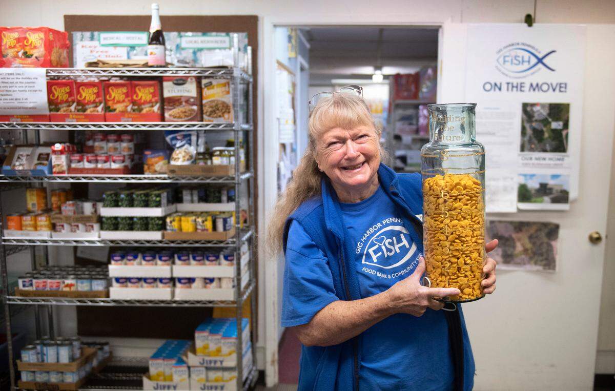 Founder Jan Coen shows the nearly full jar of fish crackers representing the $6.7 million raised - just $800,000 short of the $7.5 million goal - to build the Gig Harbor Peninsula FISH food bank’s new building just to the south of the current facility in Gig Harbor, Washington, shown on Tuesday, Nov. 16, 2021.