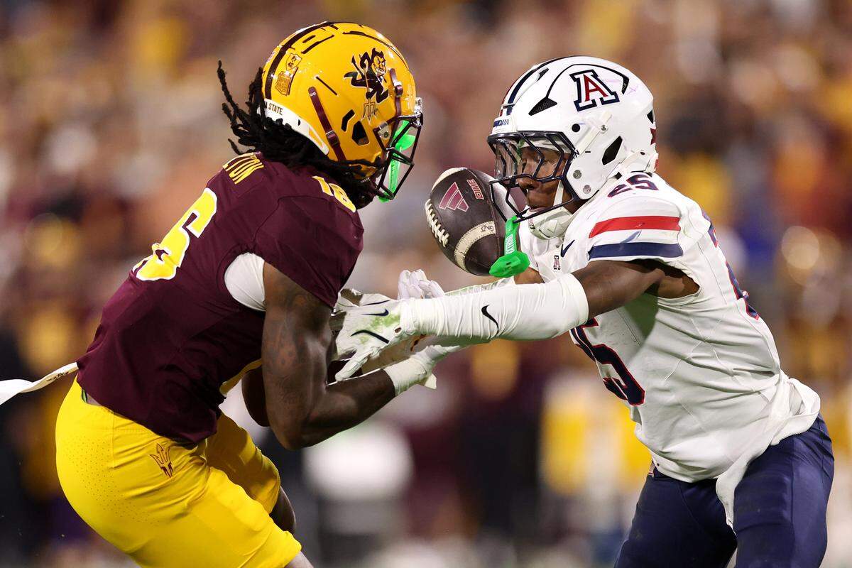 TEMPE, ARIZONA - NOVEMBER 28: Defensive back Michael Dansby #25 of the Arizona Wildcats breaks up a pass intended for wide receiver Jaren Hamilton #16 of the Arizona State Sun Devils during the first half at Sun Devil Stadium on November 28, 2025 in Tempe, Arizona. This year's game is the 99th annual Territorial Cup game between the rival Arizona schools. (Photo by Chris Coduto/Getty Images)