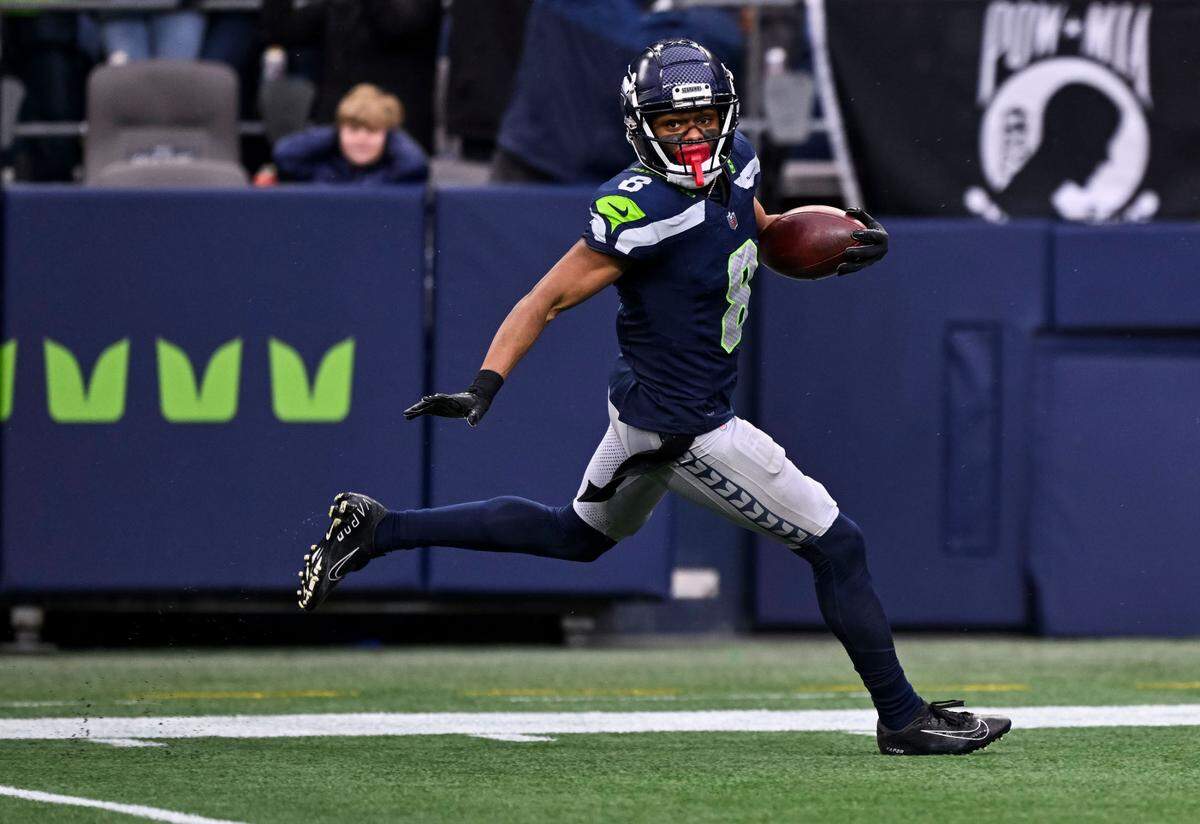 Seattle Seahawks cornerback Coby Bryant (8) run back a 69-yard interception for a touchdown during the third quarter of the game against the Arizona Cardinals at Lumen Field, on Sunday, Nov. 24, 2024, in Seattle, Wash.