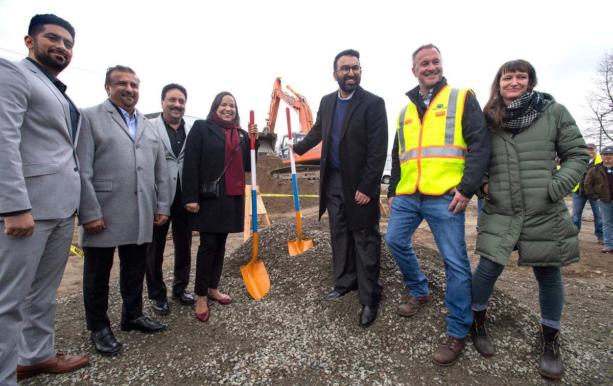 Tacoma mayor Victoria Woodards (center left) poses with property owner Tejvir Basra (center right) and other members of the development team during a groundbreaking ceremony for the Aspire11 mixed-use, multi-family residential and retail space in the Hilltop Neighborhood of Tacoma, Washington, on Wednesday, April 13, 2022.