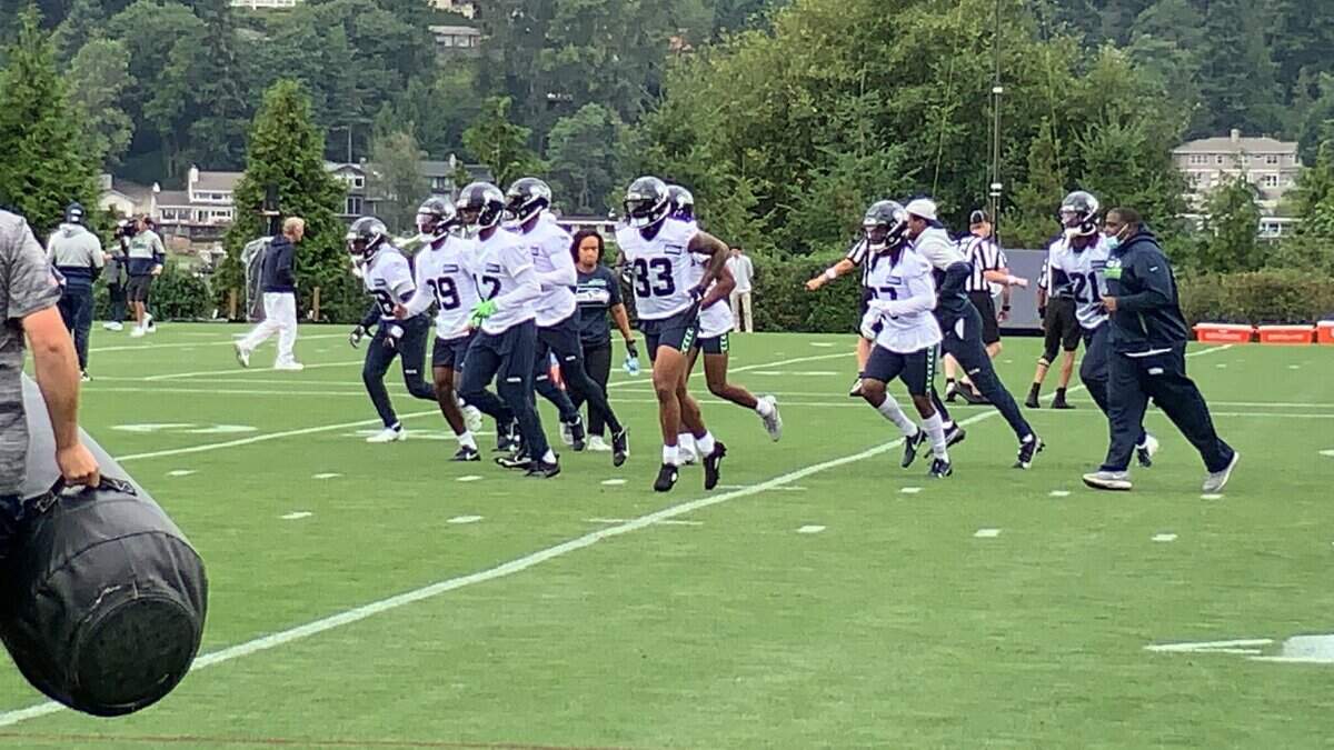 Jamal Adams (33) running with fellow Seahawks defensive players Tuesday in training camp. He practiced for the first time in camp, hours after signing a record $70 million contract extension to stay in Seattle beyond the 2021 season.