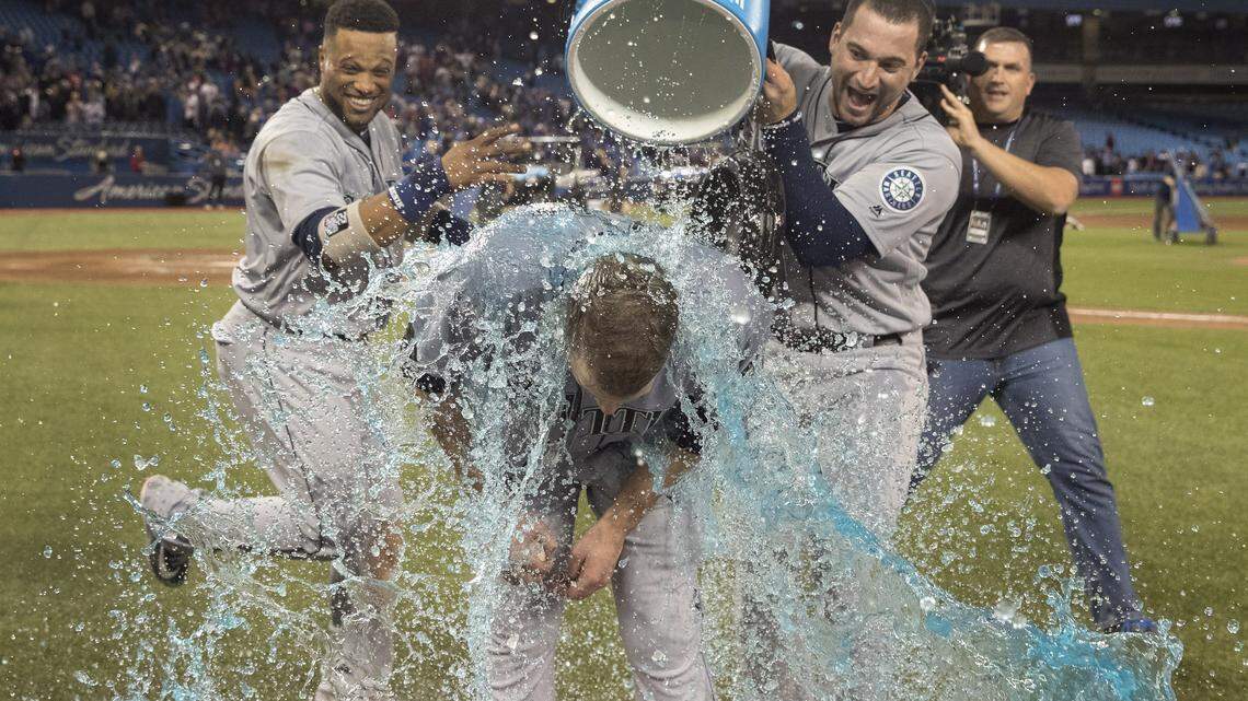 Seattle Mariners starting pitcher James Paxton is doused by teammates Robinson Cano and Mike Zunino after he pitched a no-hitter against the Toronto Blue Jays in a baseball game Tuesday, May 8, 2018, in Toronto. (Fred Thornhill/The Canadian Press via AP)