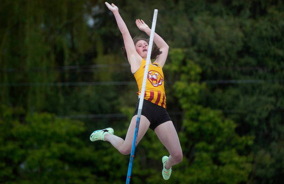 Capital High junior Hana Moll descends after clearing the bar in the girls pole vault competion at the South Sound Track Classic at Sparks Stadium in Puyallup, Washington, on Saturday, April 16, 2022.