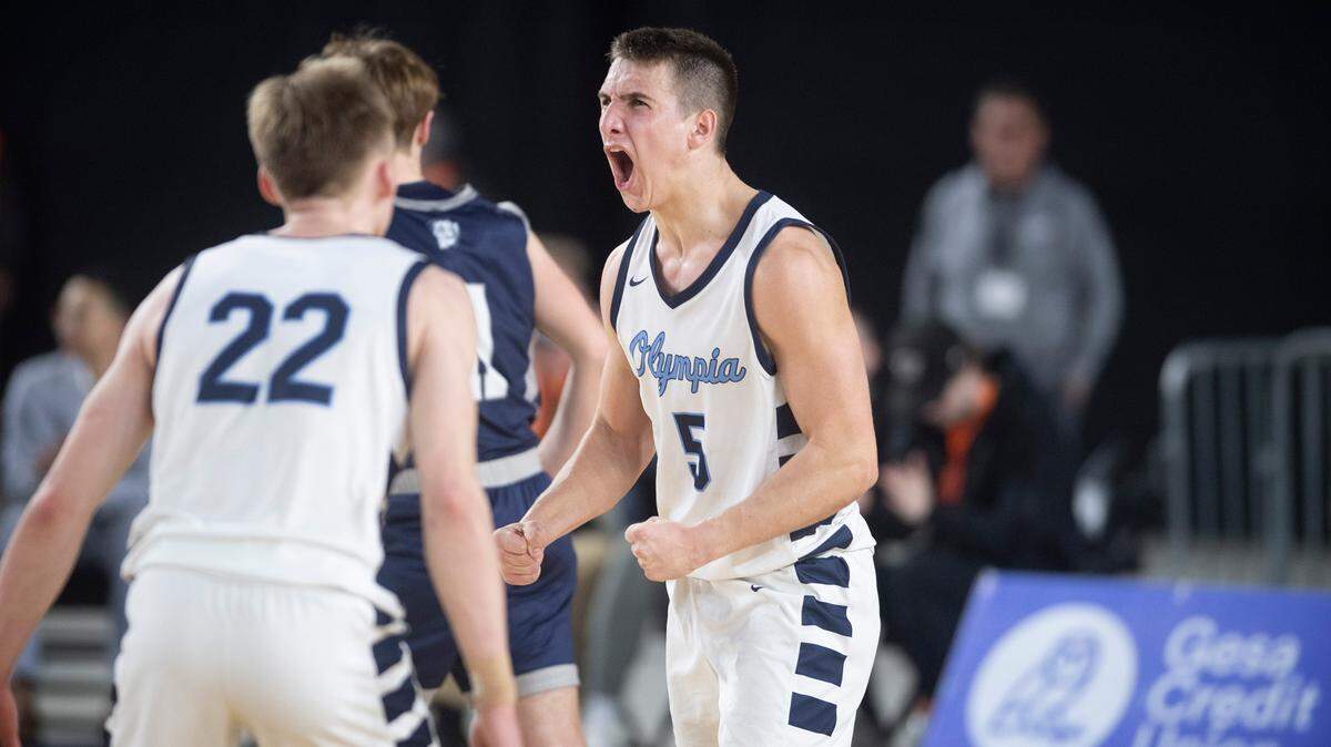 Olympia’s Mason Juergens lets out a roar after sinking two free throws to seal Bears’ quarterfinal victory over the Gonzaga Prep Bullpups during their state quarterfinal game at the WIAA state basketball tournament in the Tacoma Dome in Tacoma, Washington, on Wednesday, March 1, 2023. Olympia won the game, 51-47.