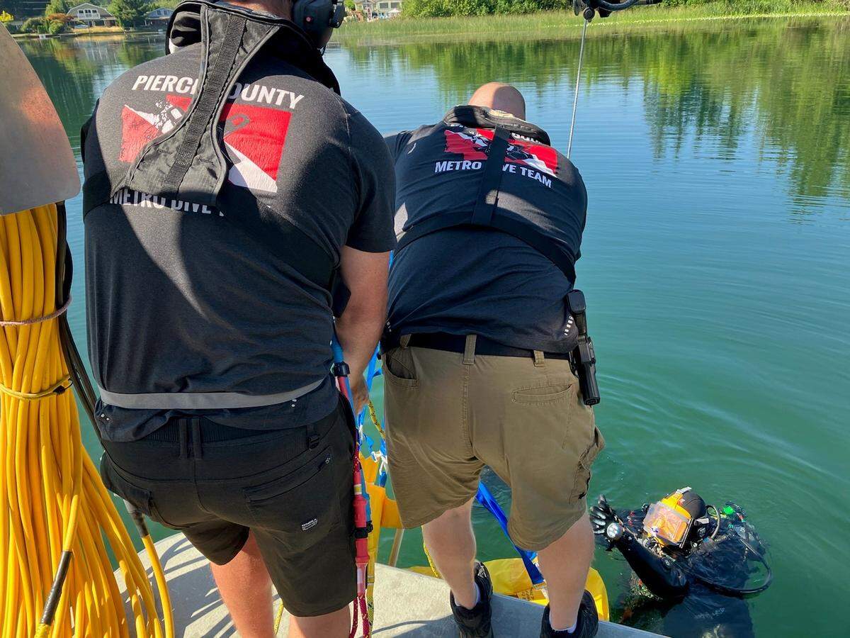 The Pierce County Metro Dive Team recovers the body of a man from Spanaway Lake Park on July 30, 2022.